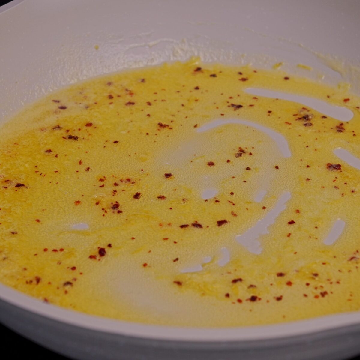 Butter sauce with spices in a pan.
