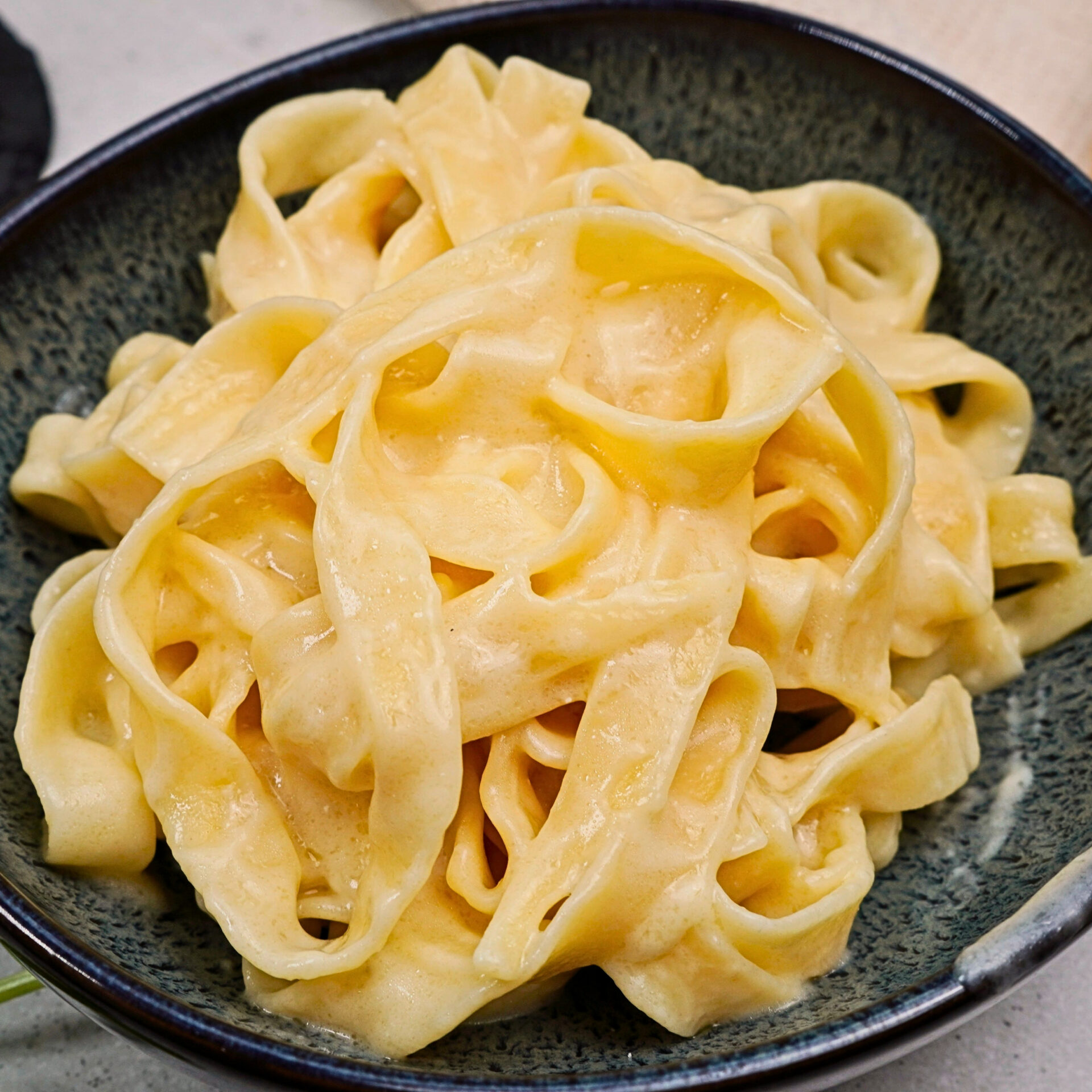 Authentic Alfredo sauce served with fettuccine in a bowl.
