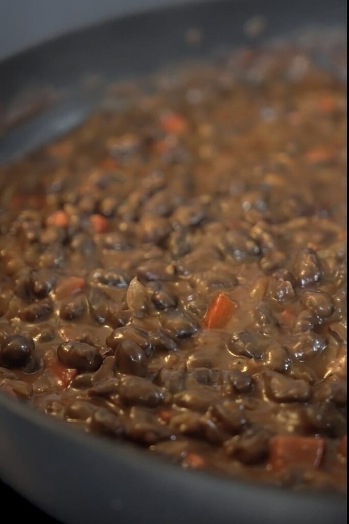 Black bean soup infusing in a pan.