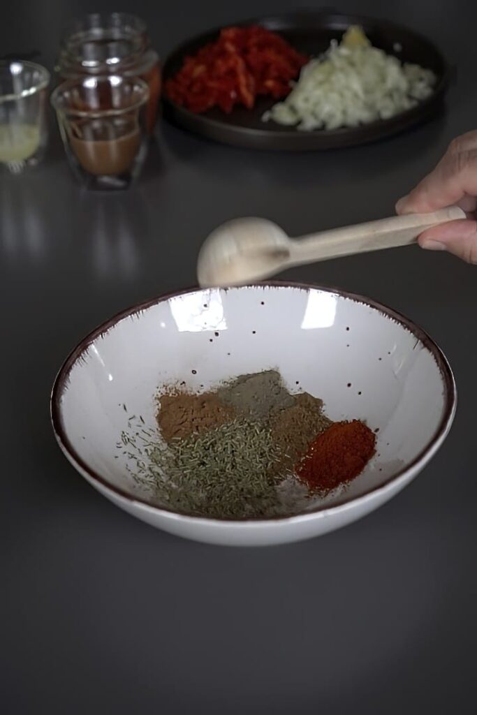 Mixing spices before making black bean soup.