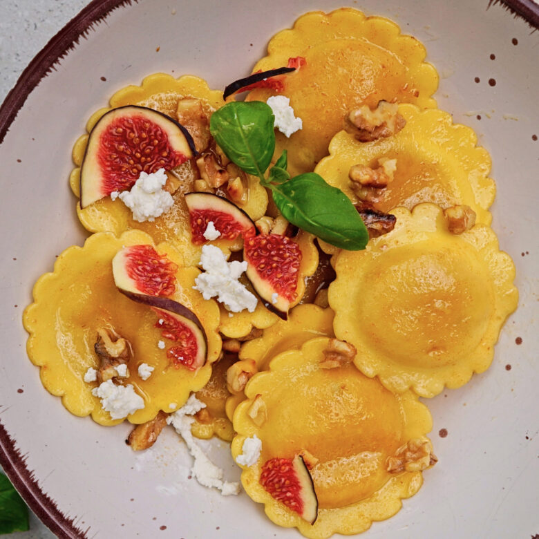 Pasta with brown butter sauce, feta, figs, and toasted walnuts served in a bowl.