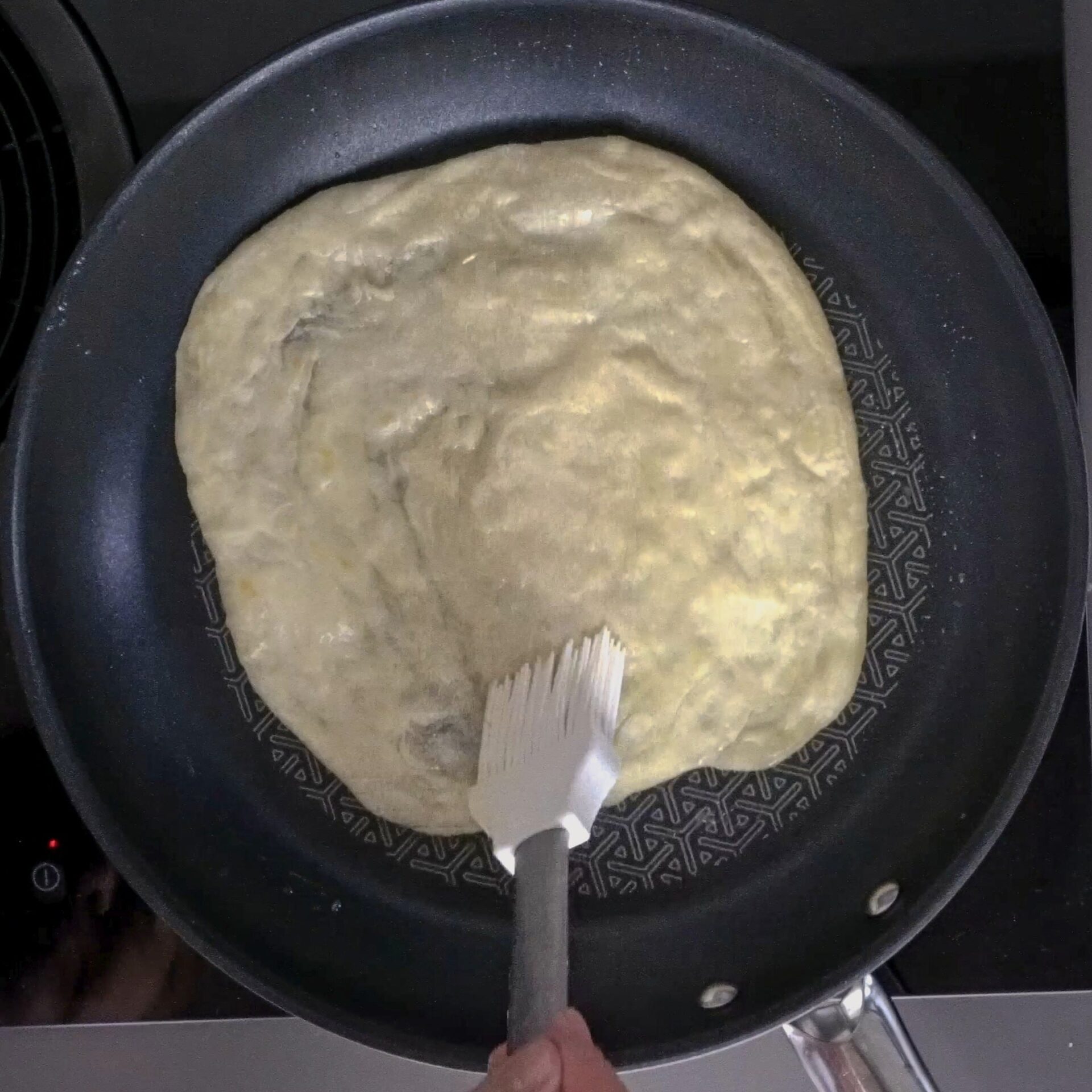 Brushing the roti with oil again for extra softness and flakiness.
