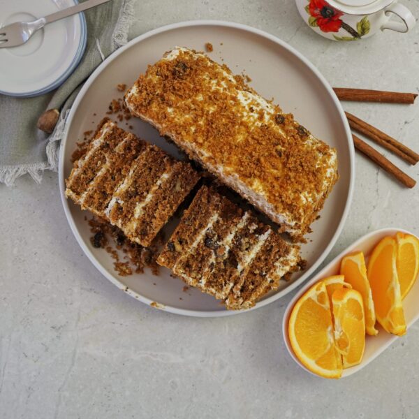 Carrot cake with cream cheese filling, cut in half to show layers, viewed from above.