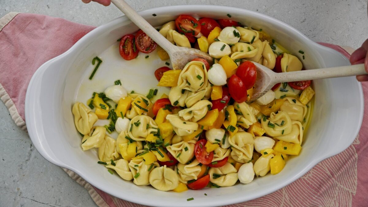 Mixing all ingredients together for salad.