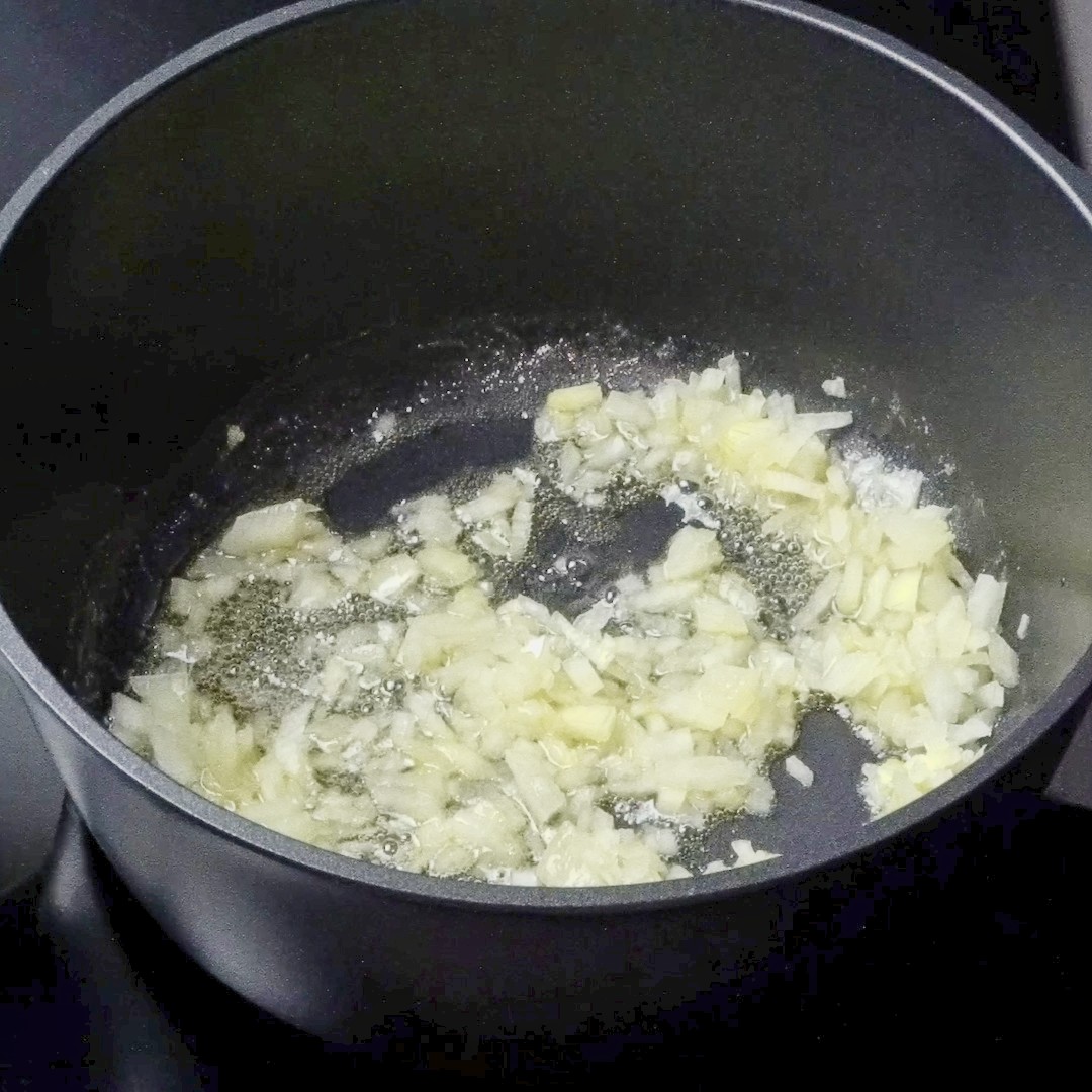 Cooking onions in butter and oil until soft and fragrant.