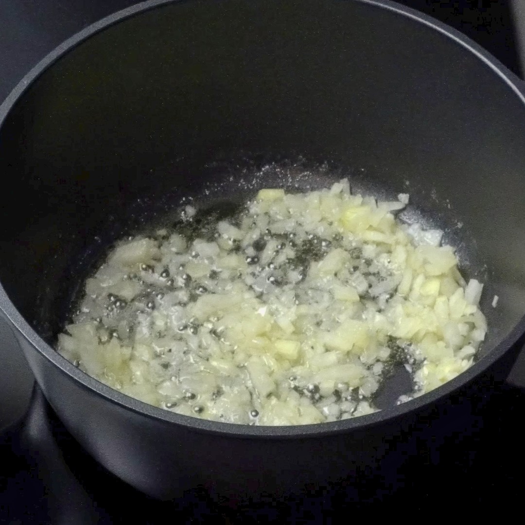 Cooking onions in a pot until soft and fragrant.