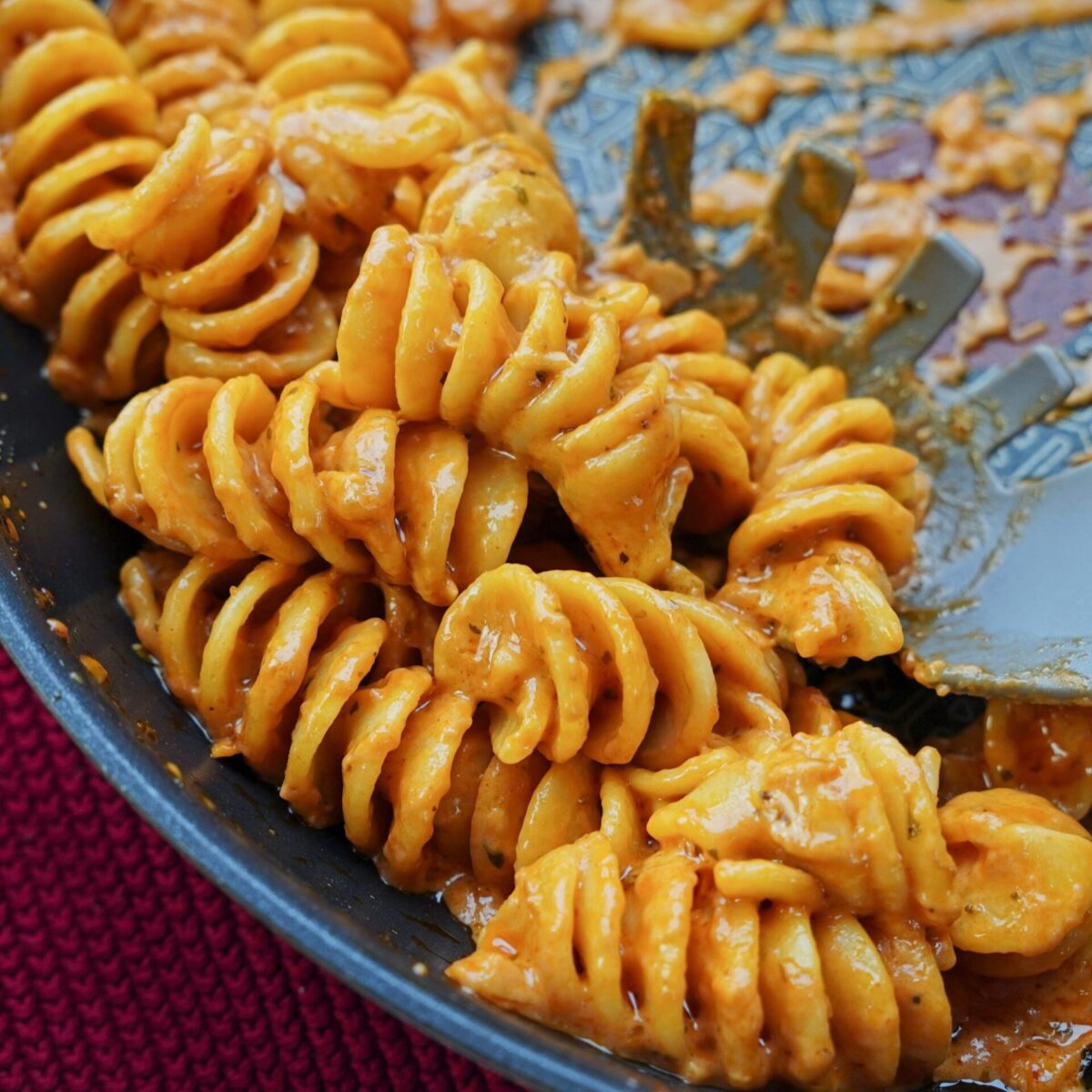 Close-up of freshly cooked creamy tomato pasta in a pan.