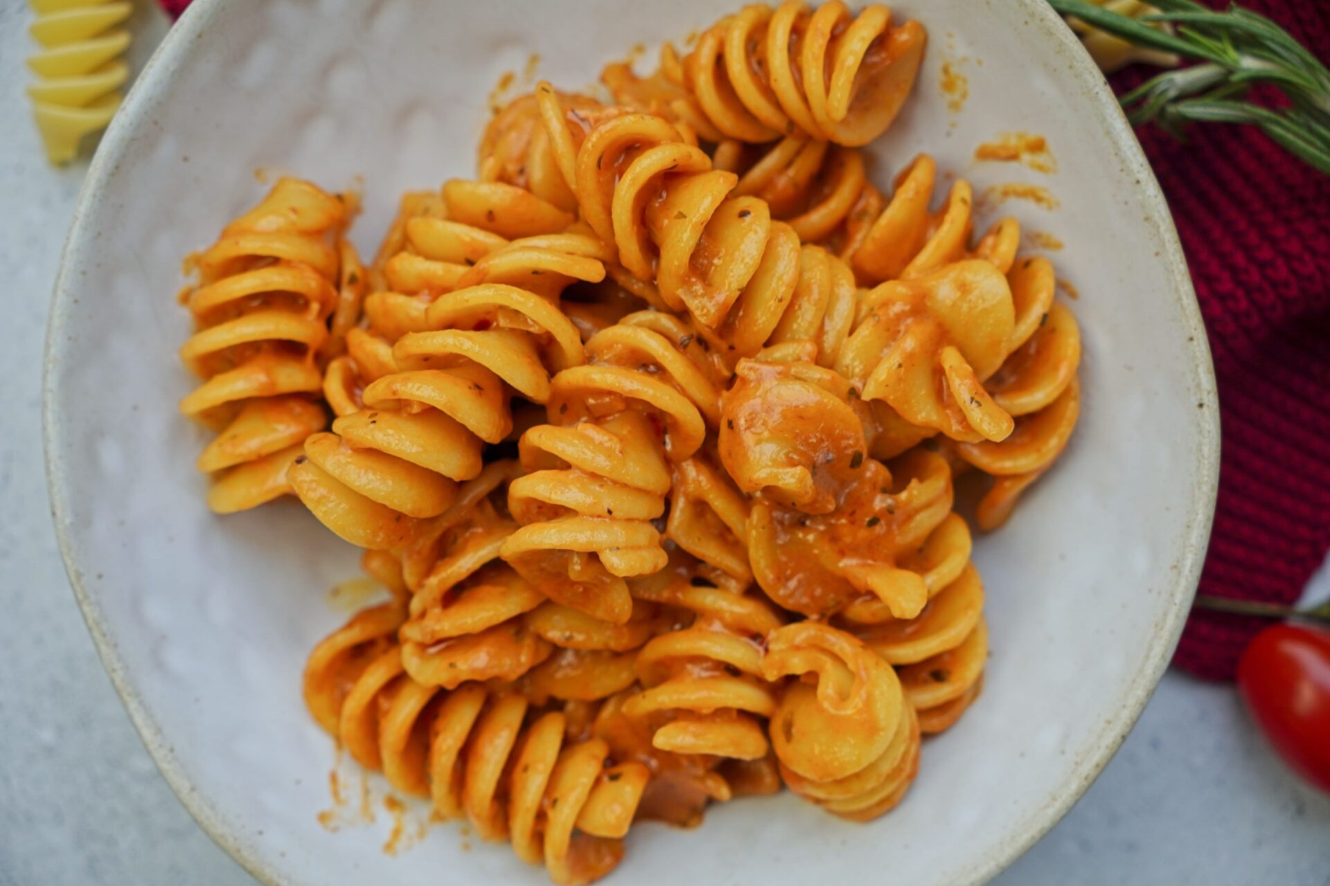 Close-up, top-down view of pasta with creamy tomato sauce.