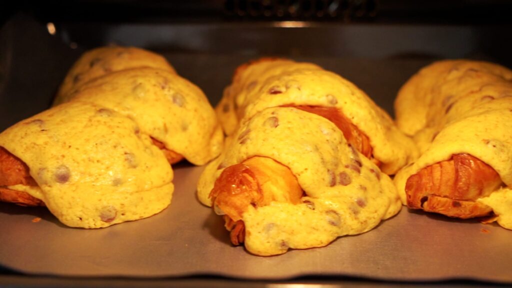 Crookies baking in the oven with cookie dough topping.