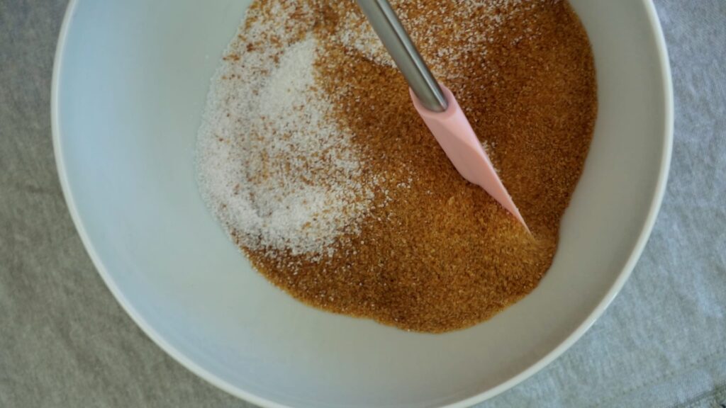 Mixing three types of sugar: brown, white, and vanilla.