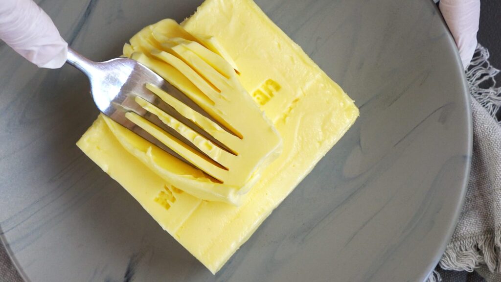 Soft butter on a plate, ready to make cookie dough for croissant filling.