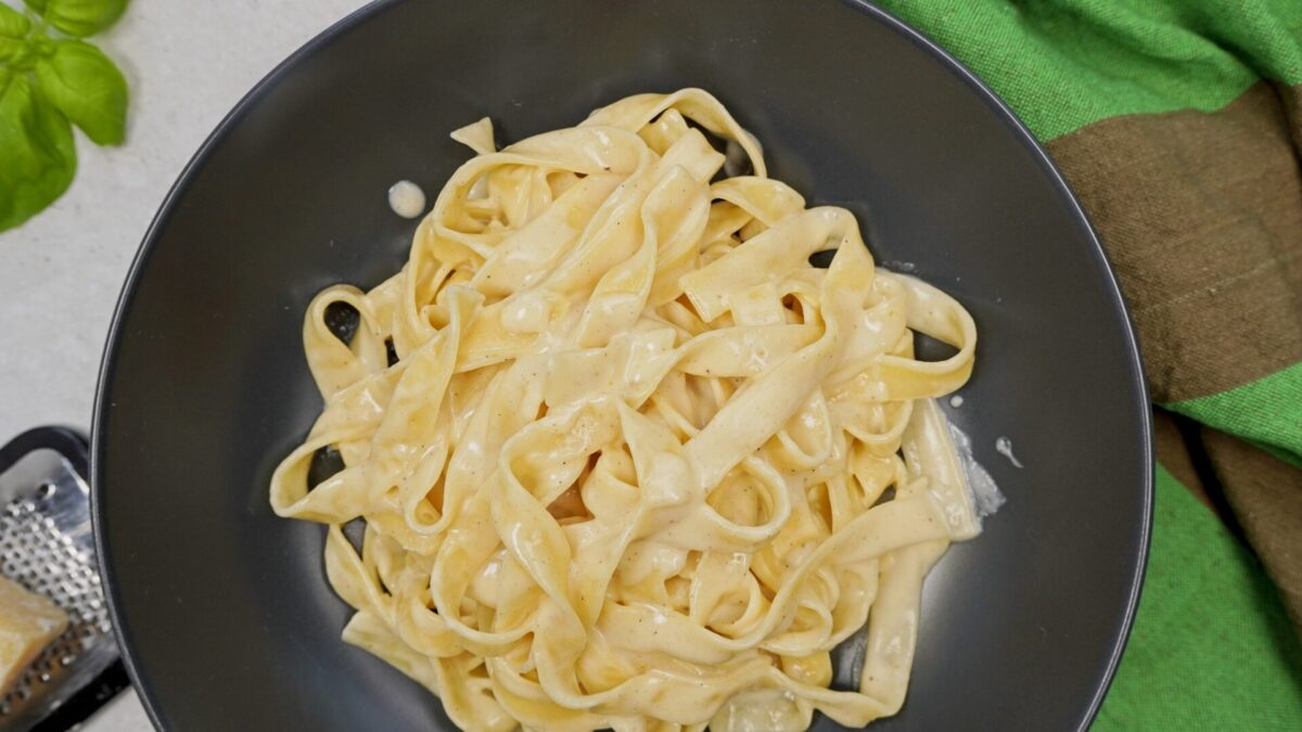 Easy fettuccine Alfredo ready in minutes served on a plate from above.