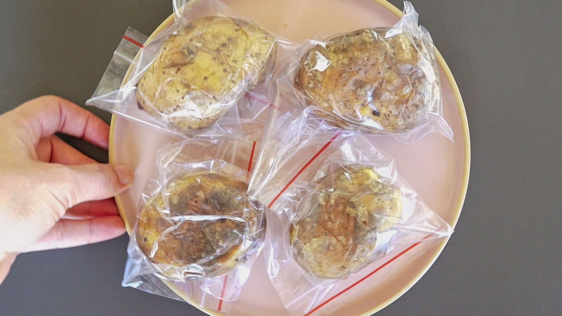Placing potatoes in Ziploc bags before freezing.