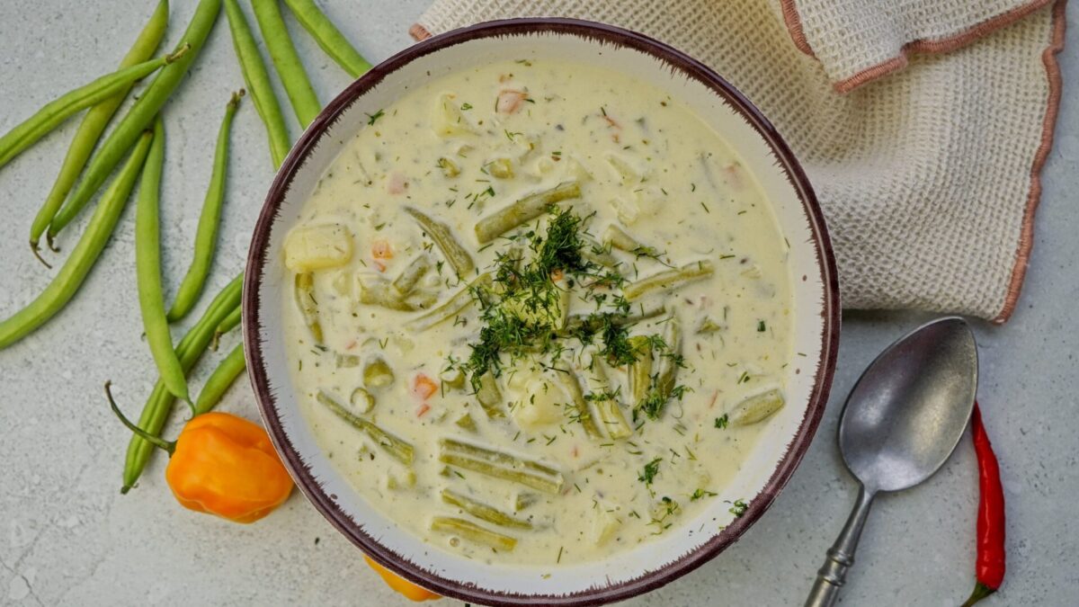 Top-down view of vegetarian green bean soup garnished with dill.