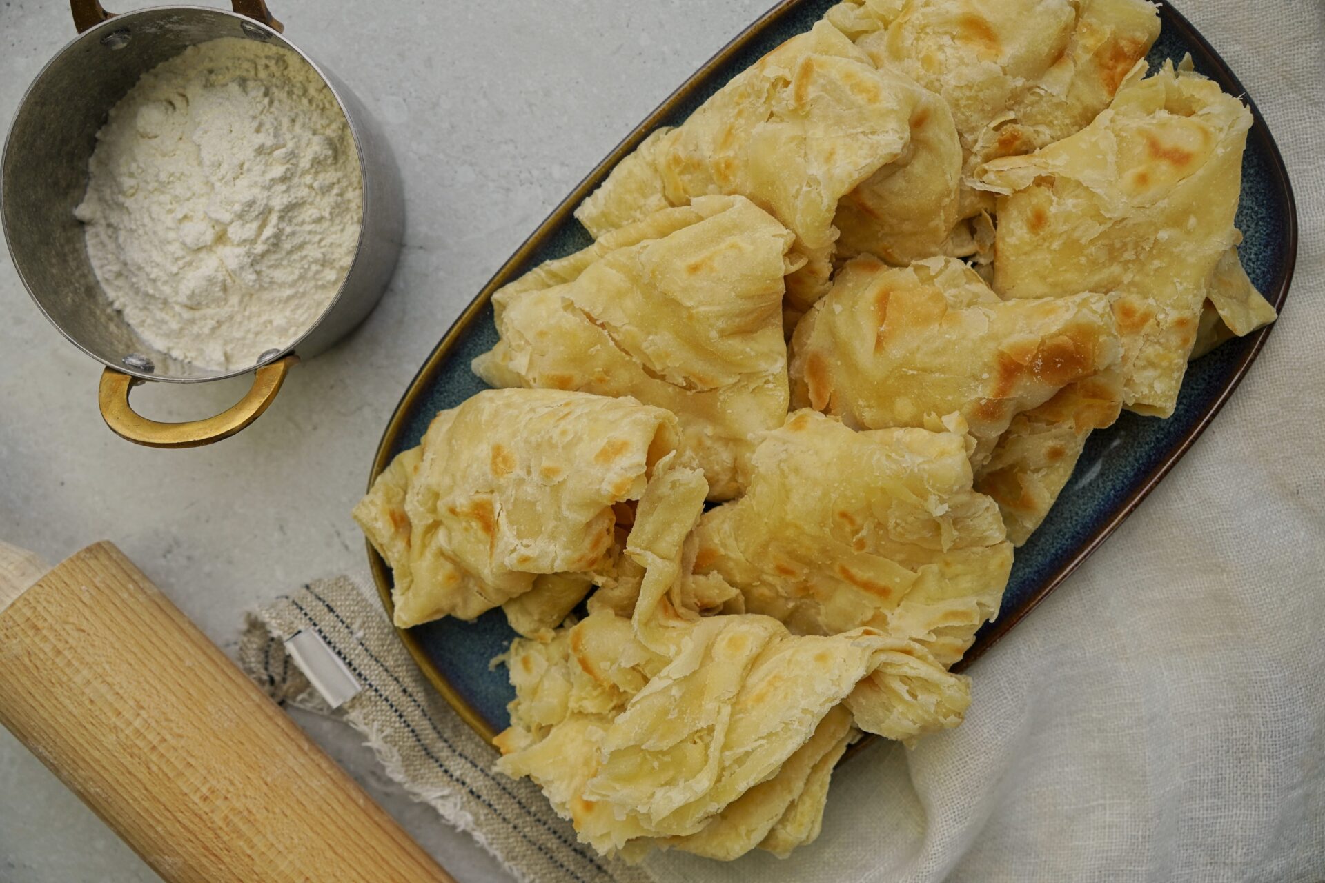 Guyanese roti with a rolling pin on the side.