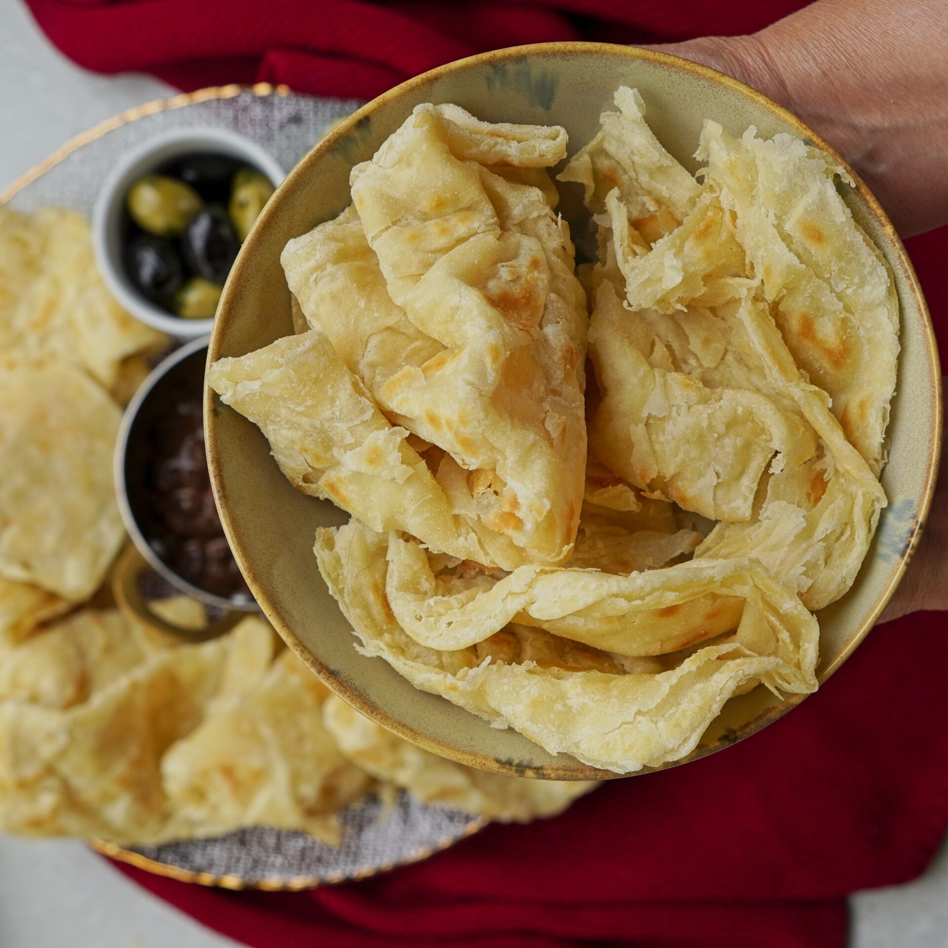 A bowl full of freshly cooked roti, ready to serve.