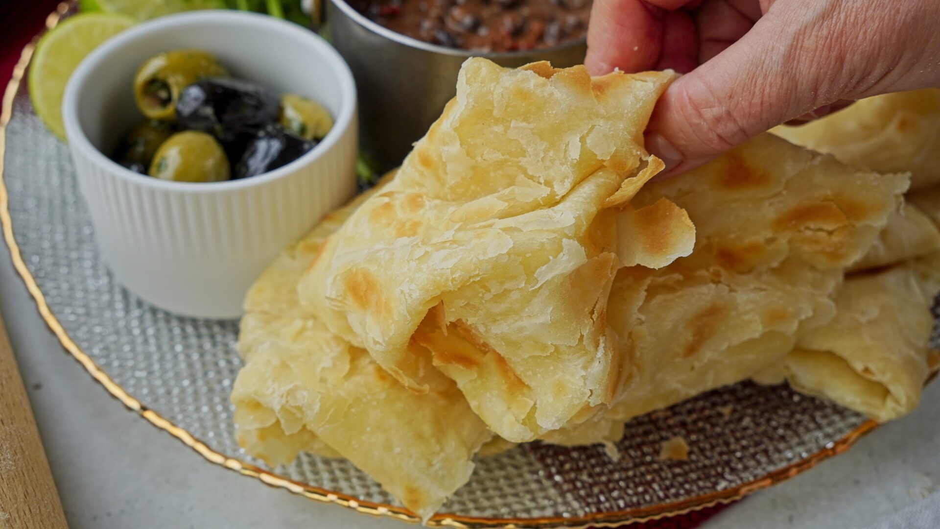 Person holding a piece of extra soft Guyanese roti.
