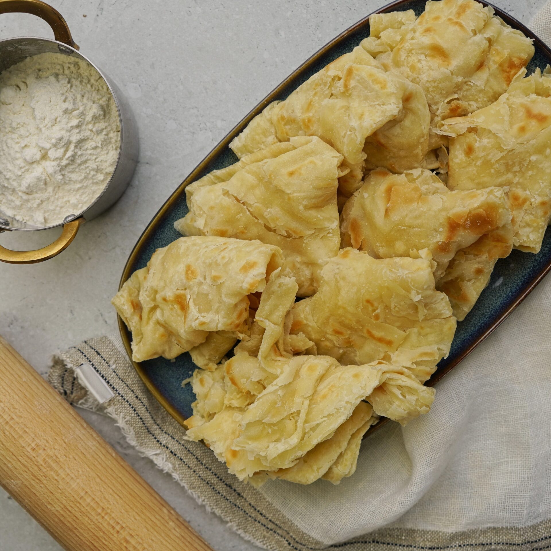 Freshly cooked Guyanese roti on a plate, ready to enjoy.