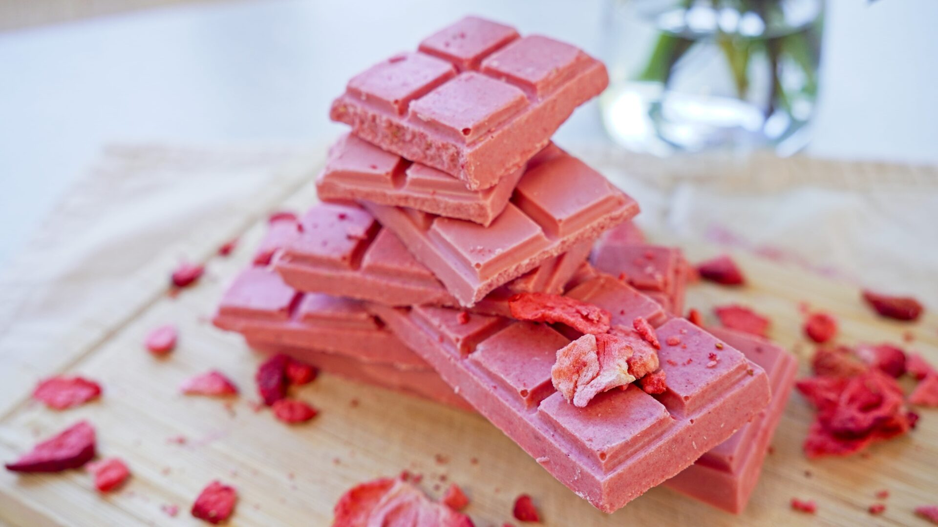 Pieces of pink chocolate stacked on top of each other, showcasing its airy texture.