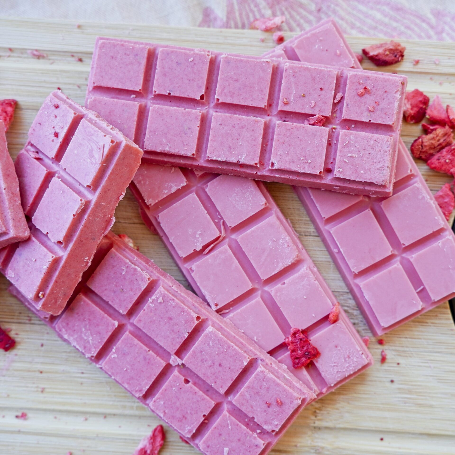 Top view of pink chocolate colored with freeze-dried strawberries and food coloring.