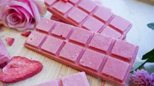 Pink chocolate with natural coloring in the foreground, with food coloring in the background.