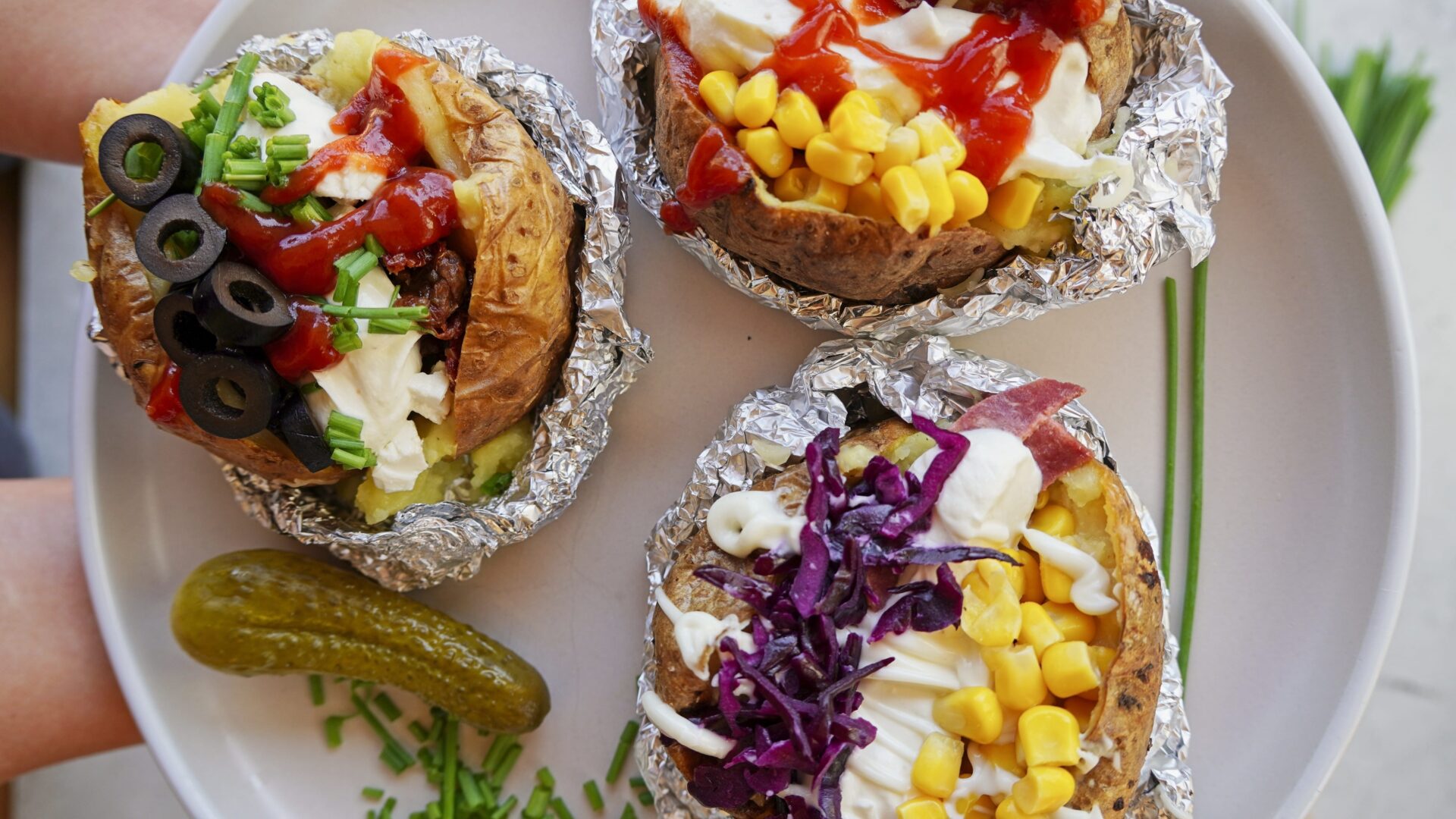 Baked potatoes, also known as kumpir, loaded with delicious toppings on a plate, ready to be enjoyed anytime.