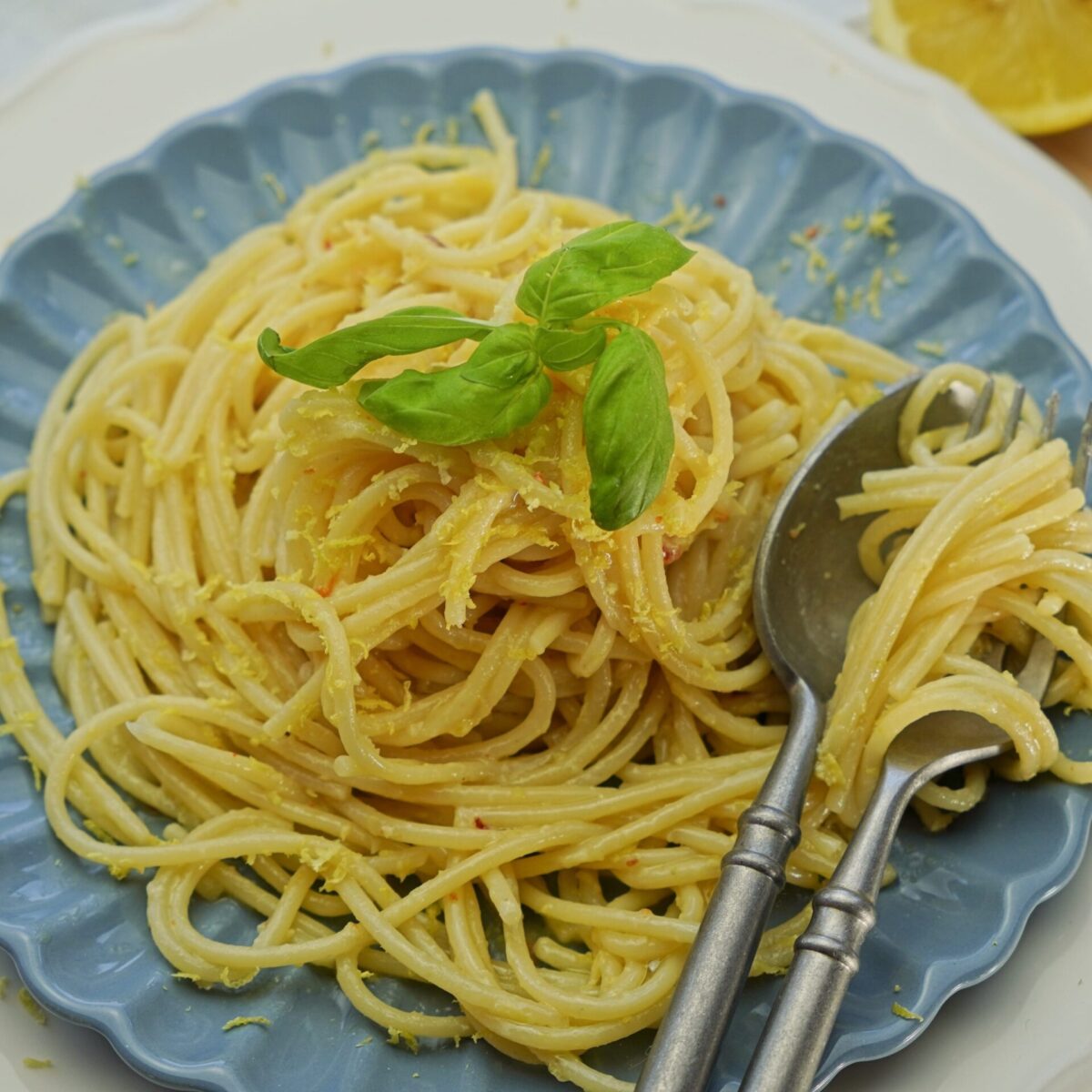 Plate of al dente pasta coated in rich, extra creamy lemon butter sauce.