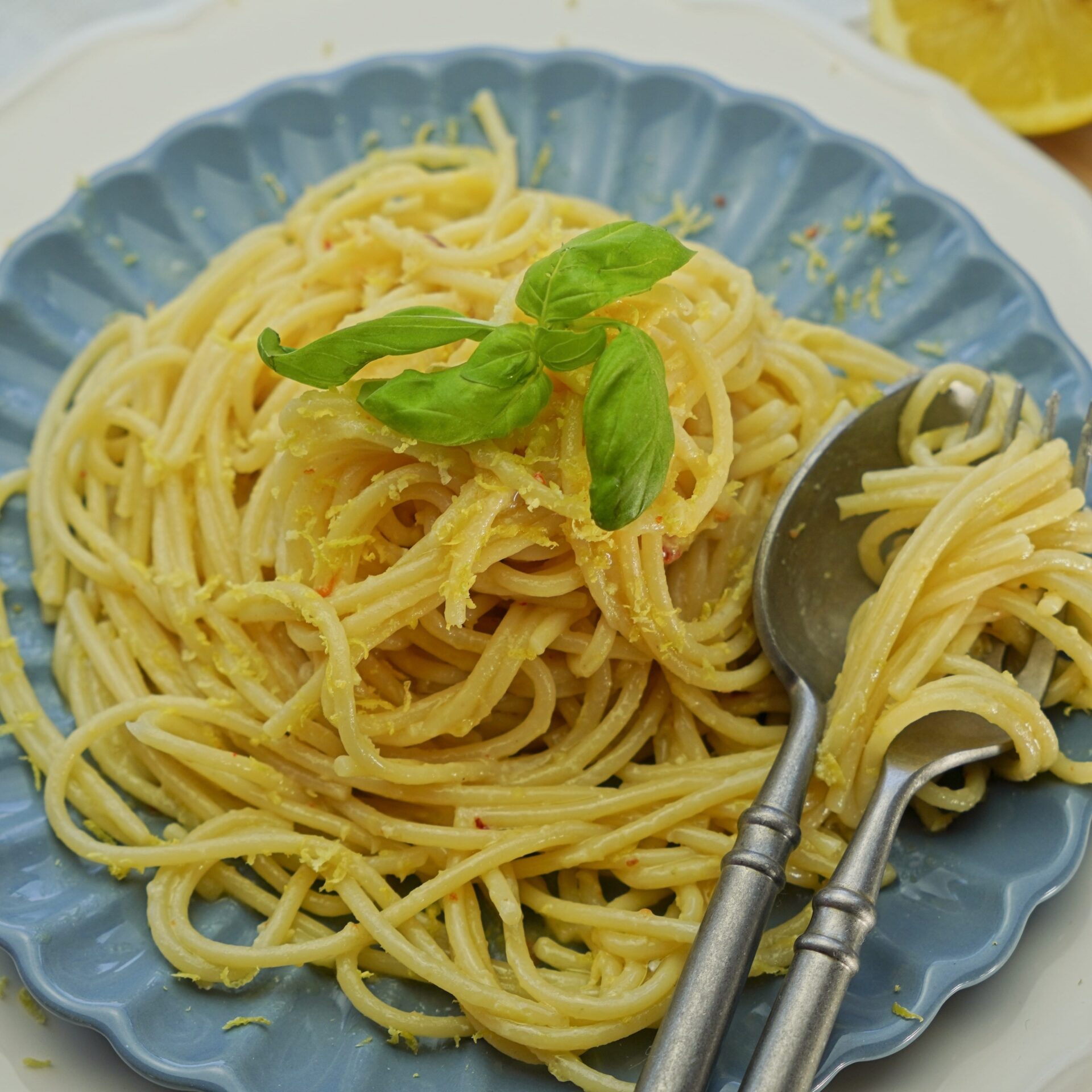 Plate of al dente pasta coated in rich, extra creamy lemon butter sauce.