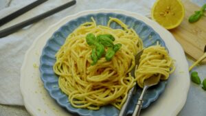 Lemon butter cream pasta warmed up from the fridge, served with fresh basil leaves on top.