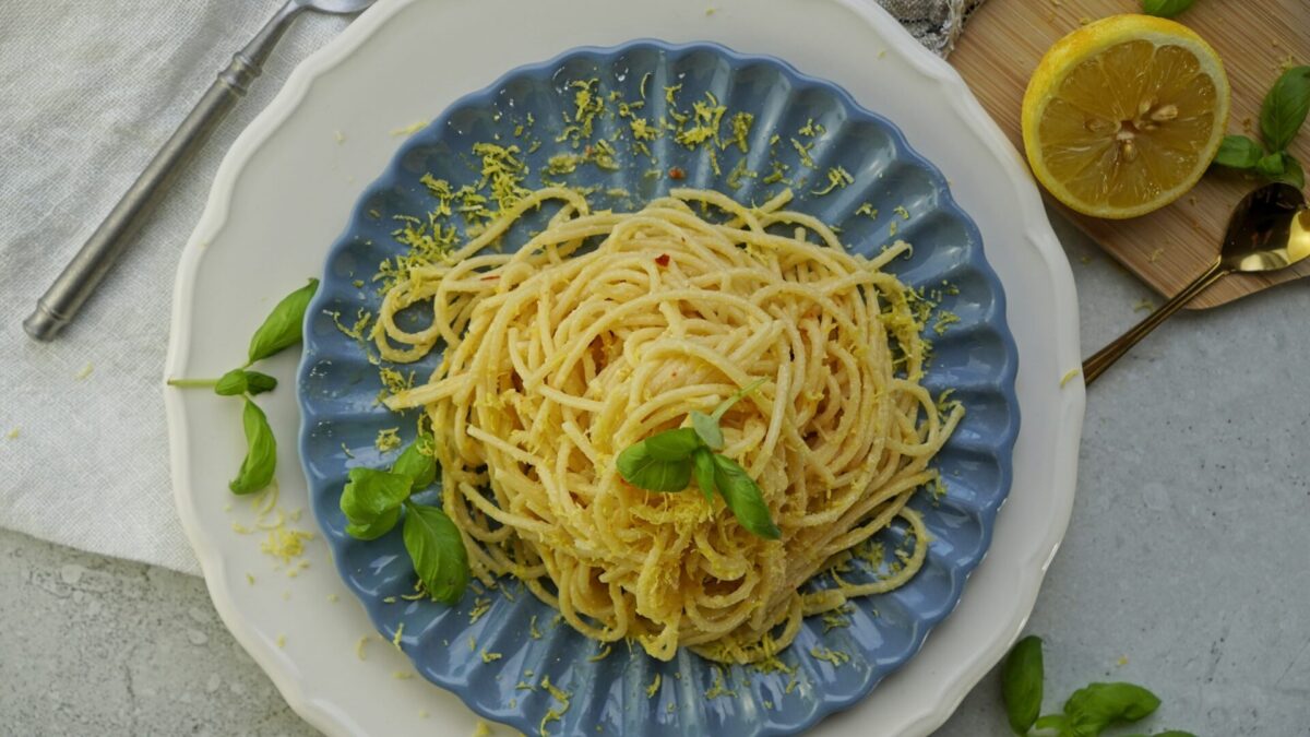 Top-down view of spaghetti coated in extra creamy lemon butter sauce.