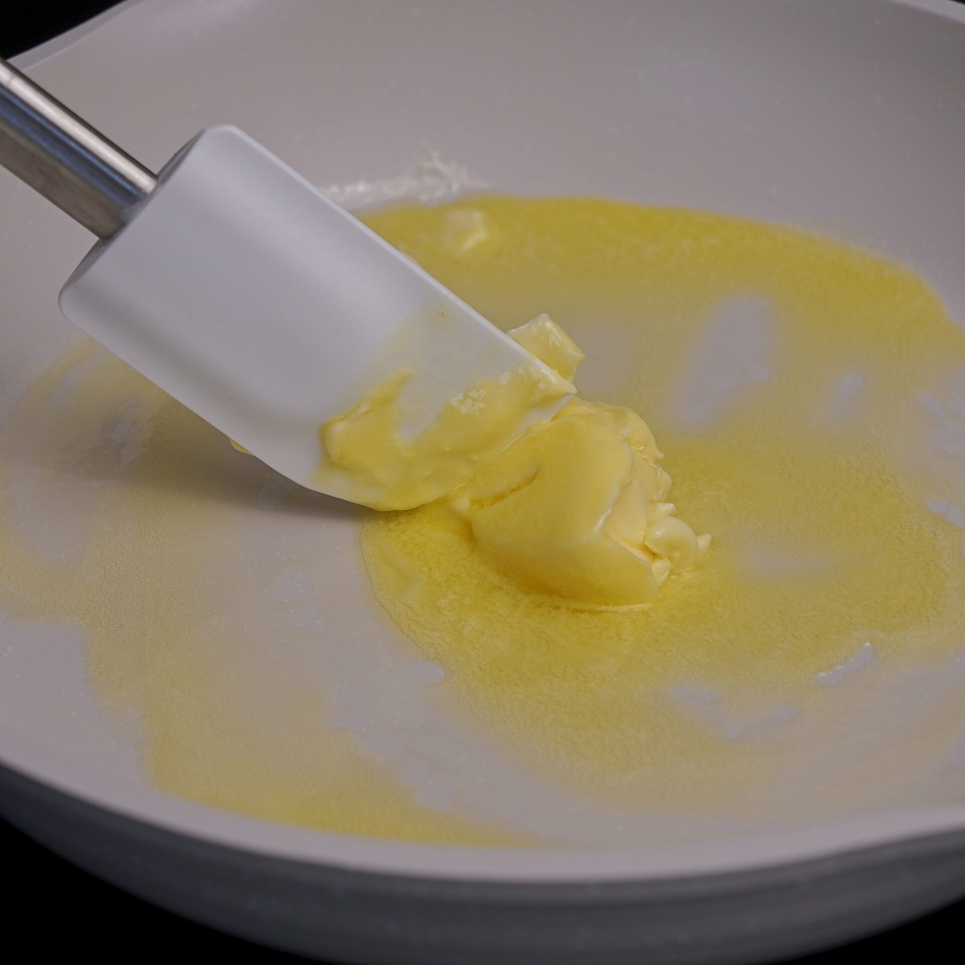 Gently melting butter in a pan for a sauce.