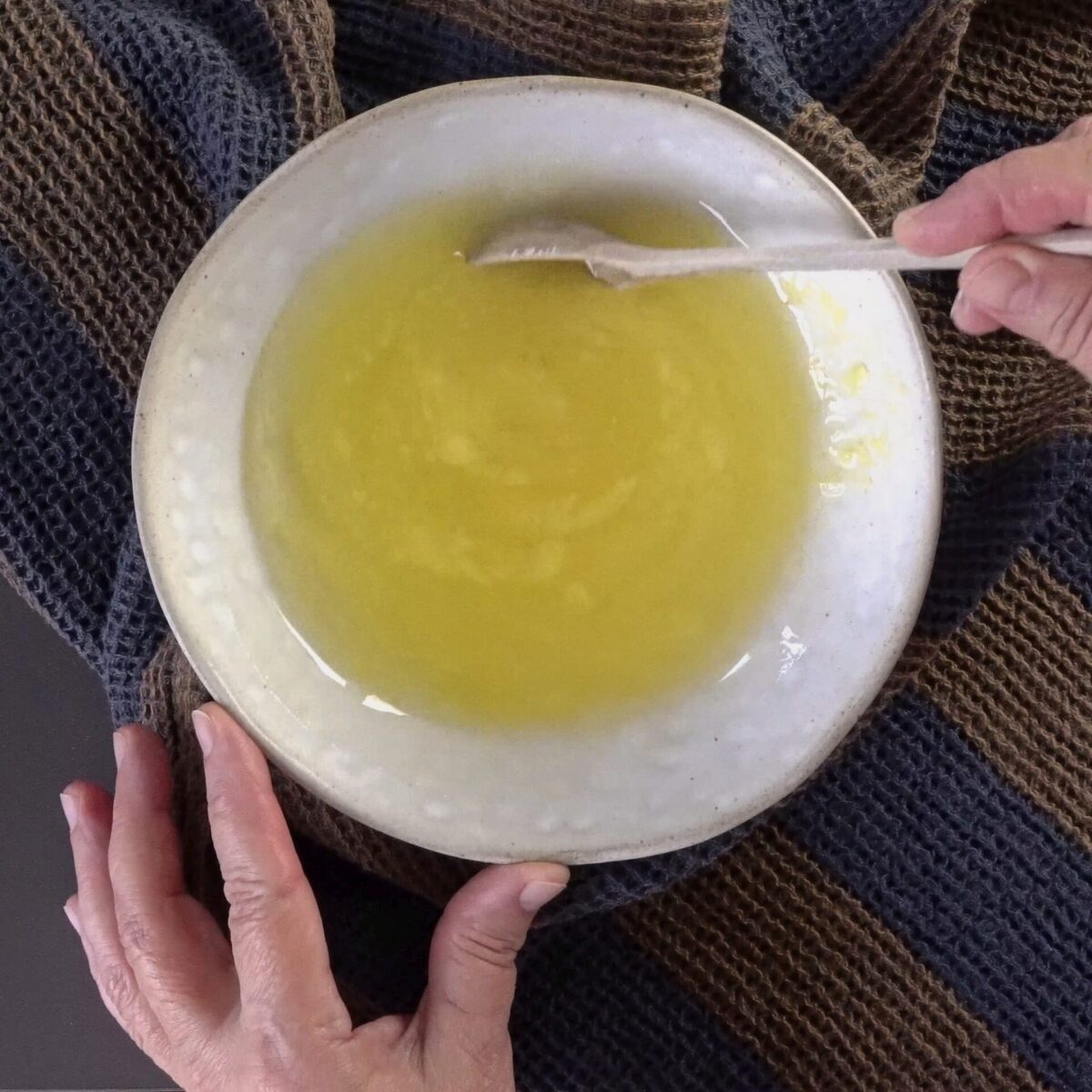 Mixing oil and butter to create a smooth roti brushing mixture.