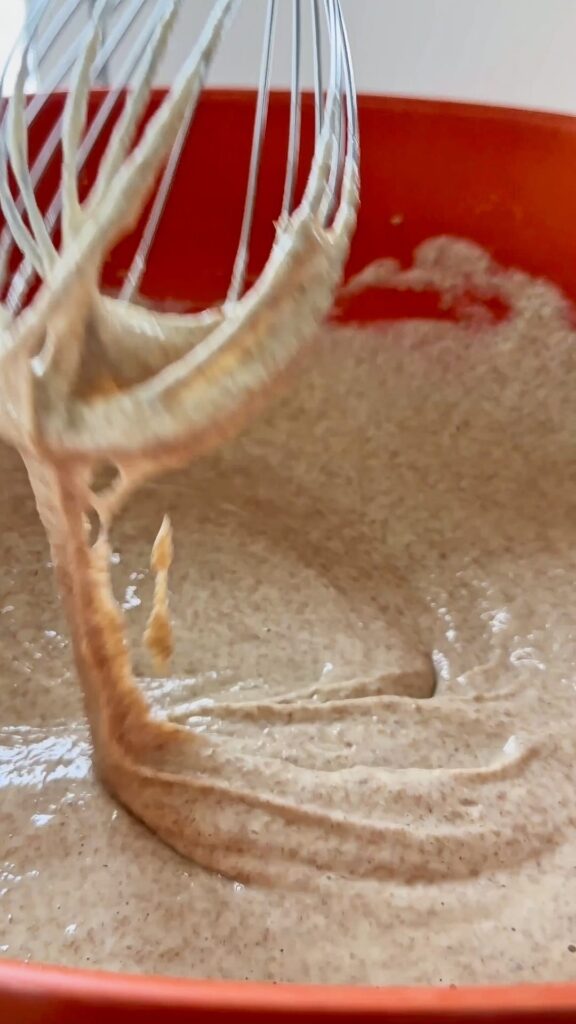 Mixing mushroom batter with a whisk.