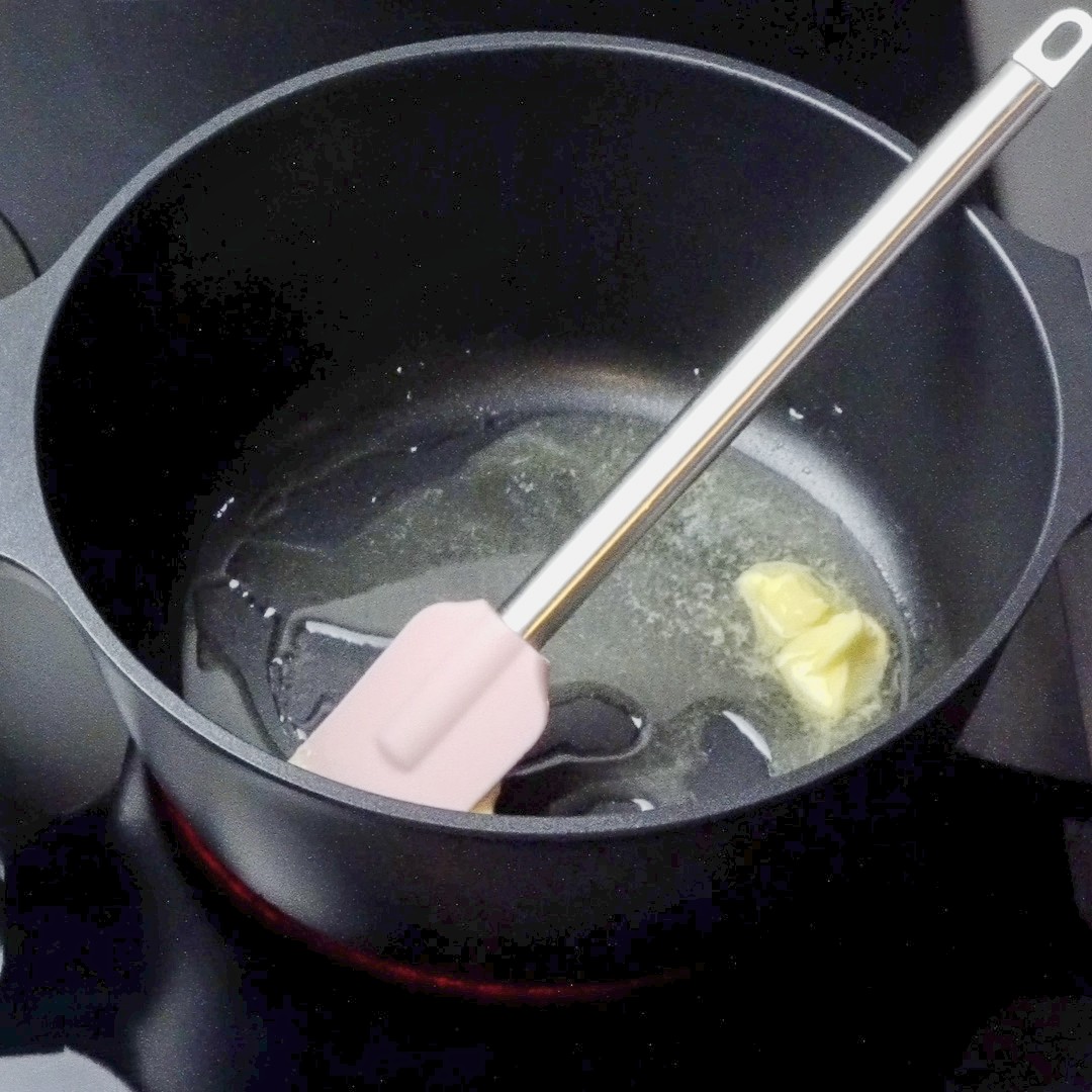 Oil and butter heating in a pan on the stovetop.