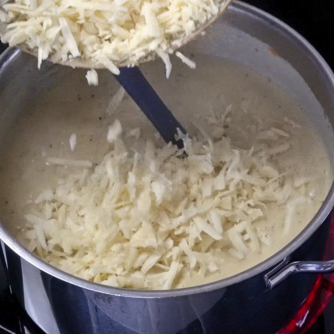 Adding even more cheese to the soup for extra creaminess.