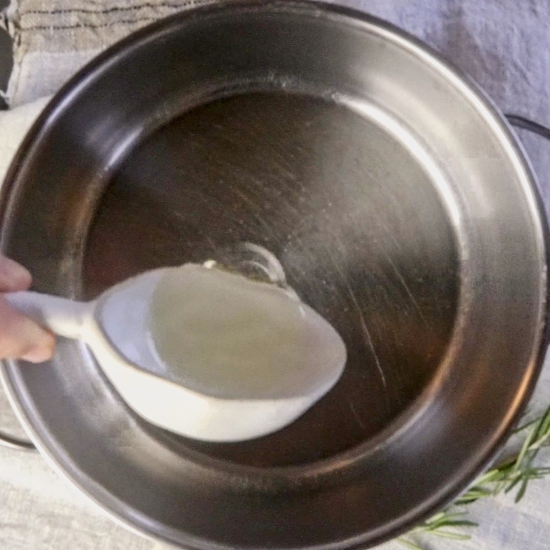 Pouring sunflower oil into the pot.