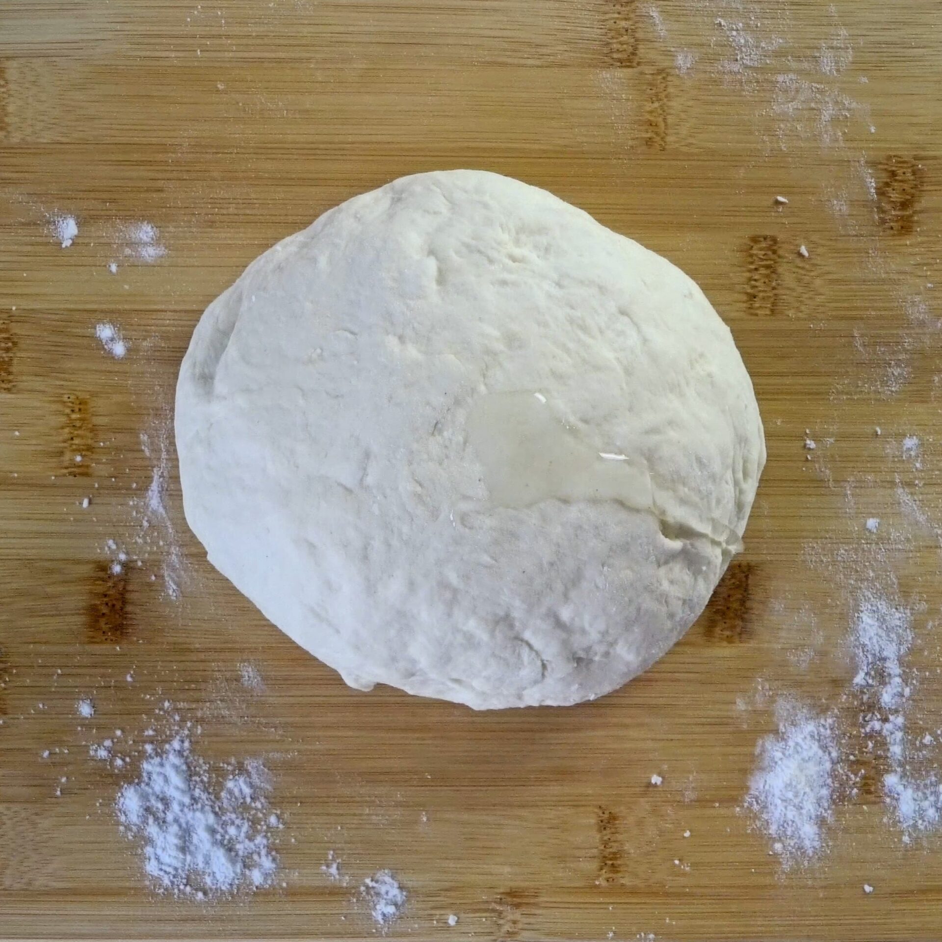 Soft, oiled dough ball ready for resting.