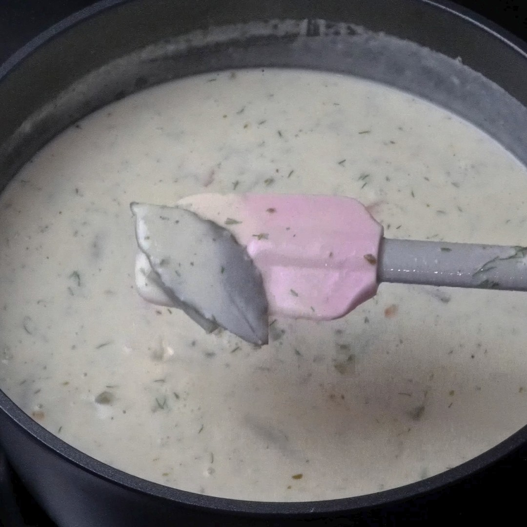 Removing bay leaves from the soup.