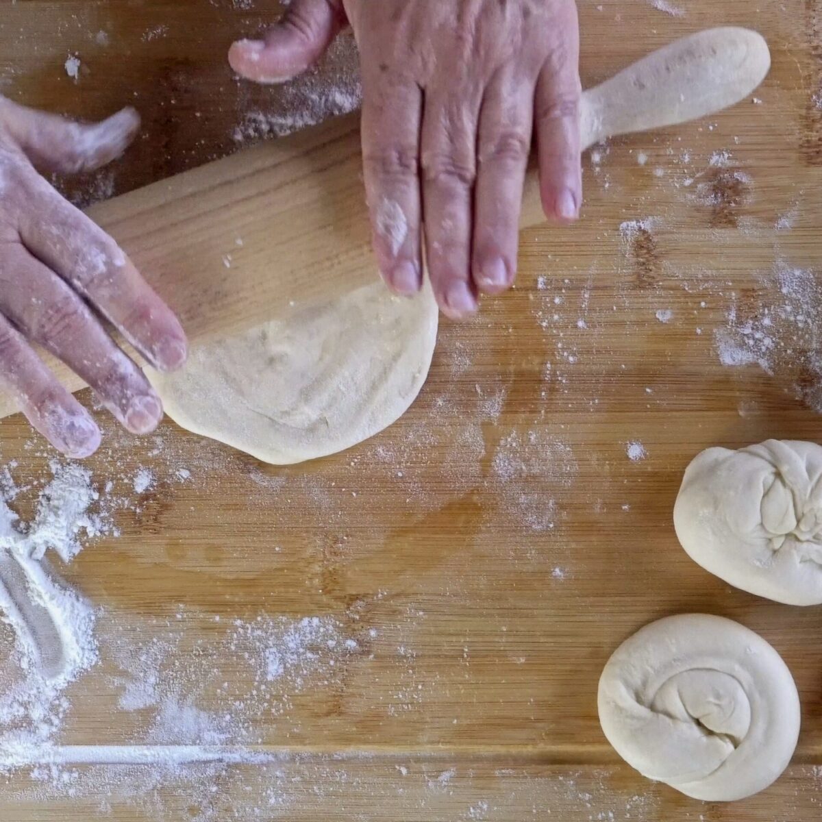 Rolling out the roti dough before cooking.