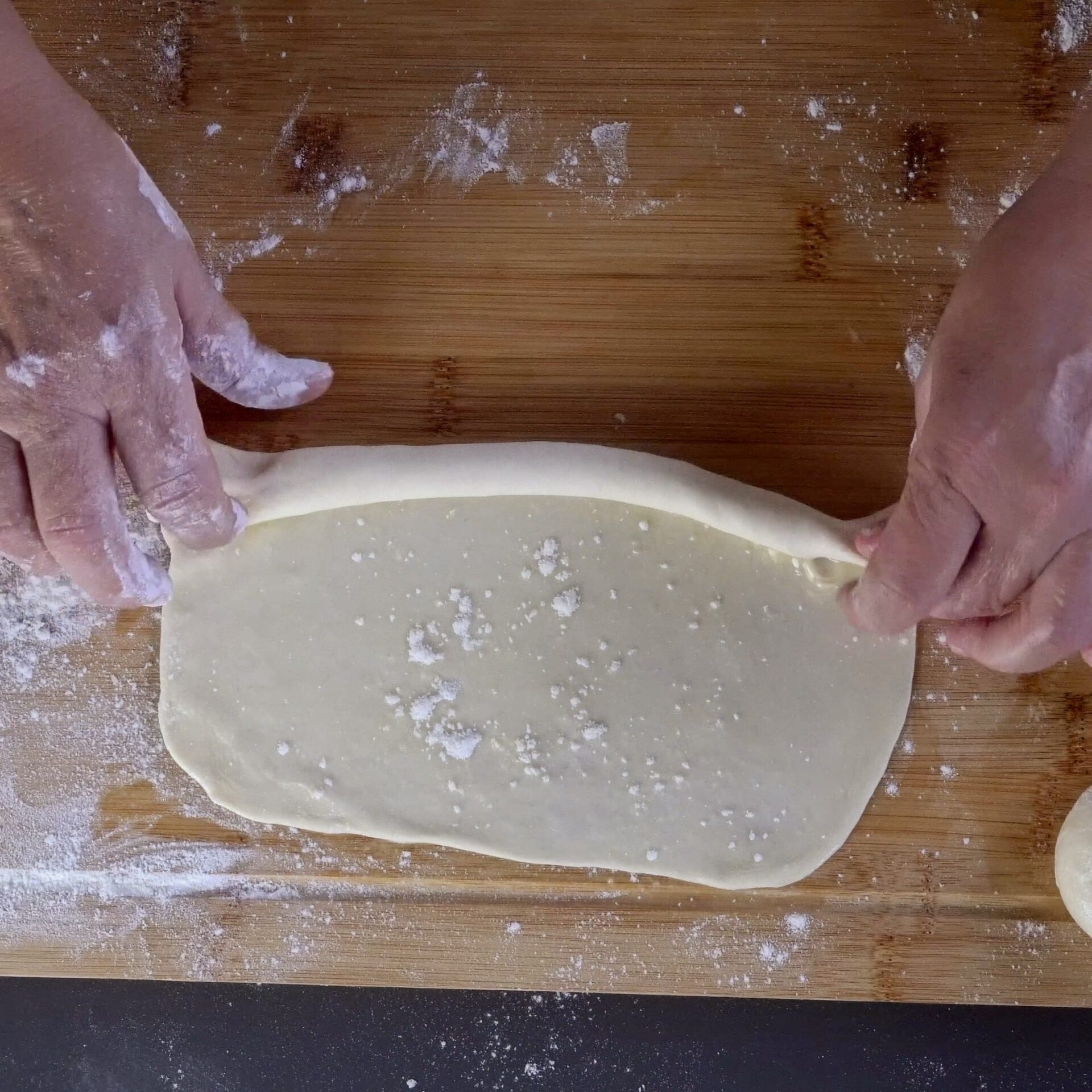 Rolling the dough into a log for layering.