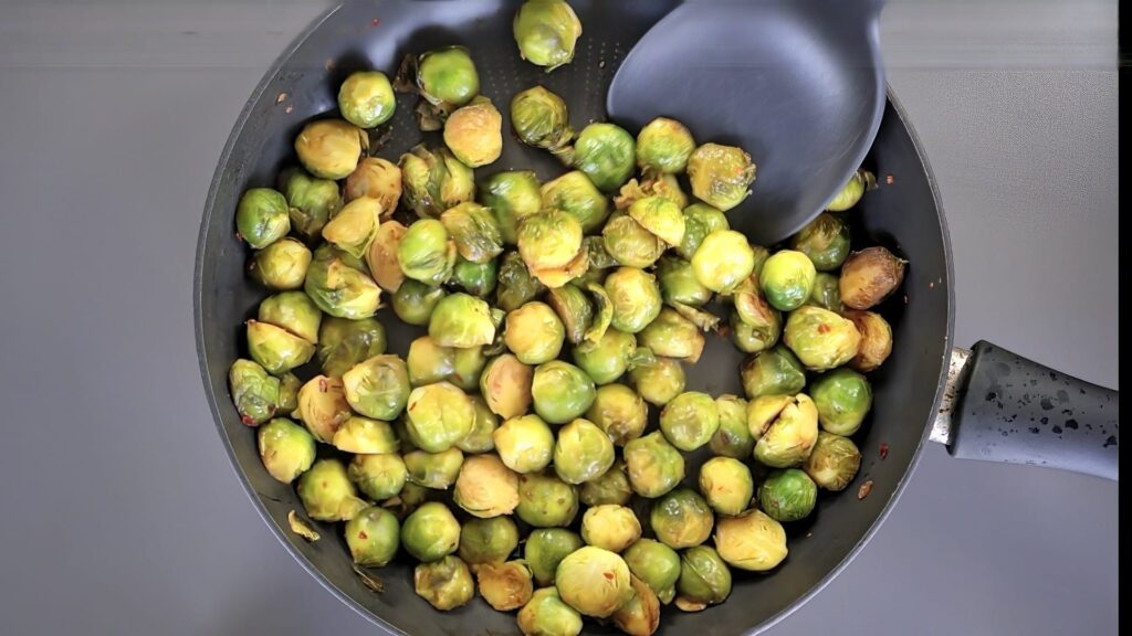 Seasoned Brussels sprouts in a pan after roasting. 