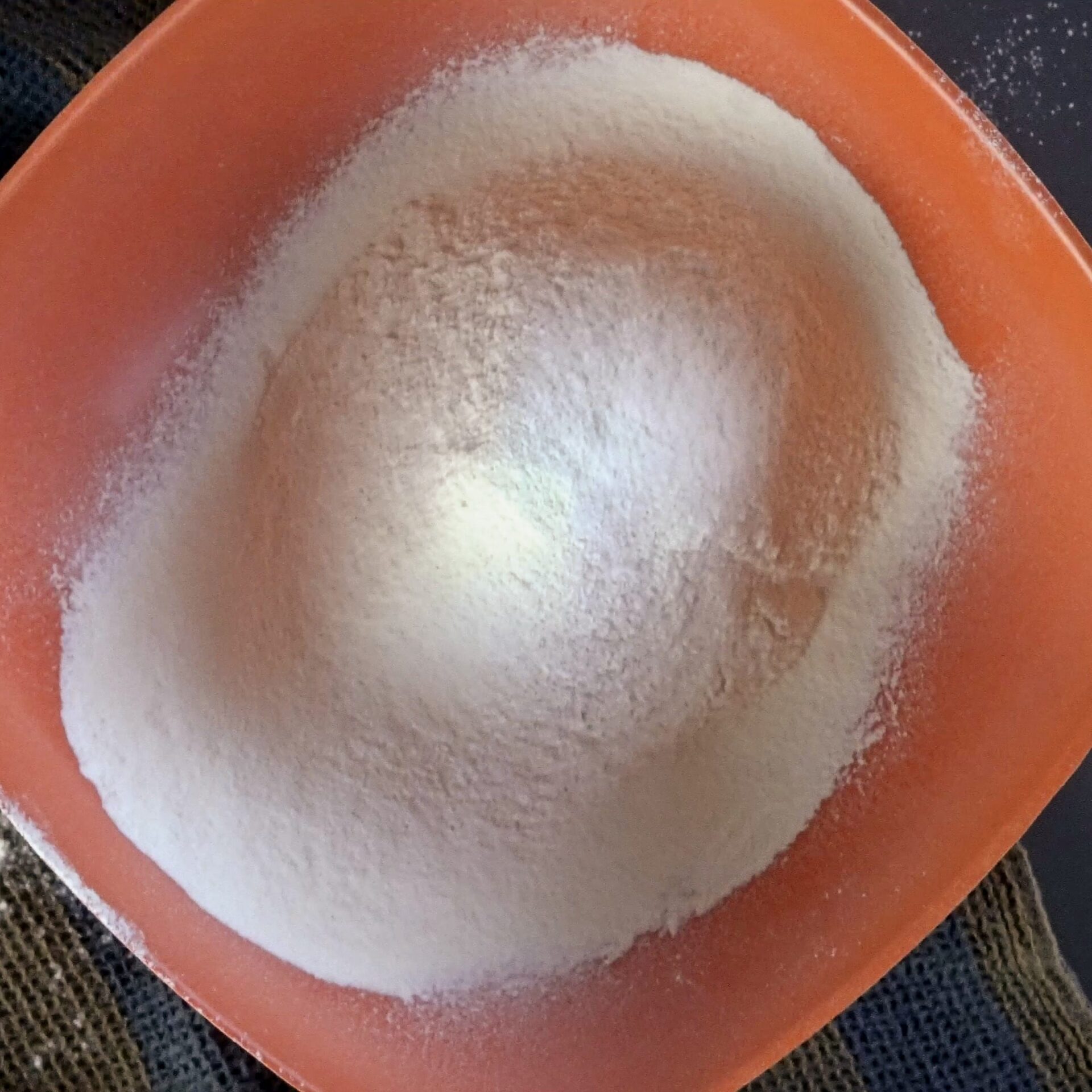 Sifted flour in a bowl, ready for making roti dough.
