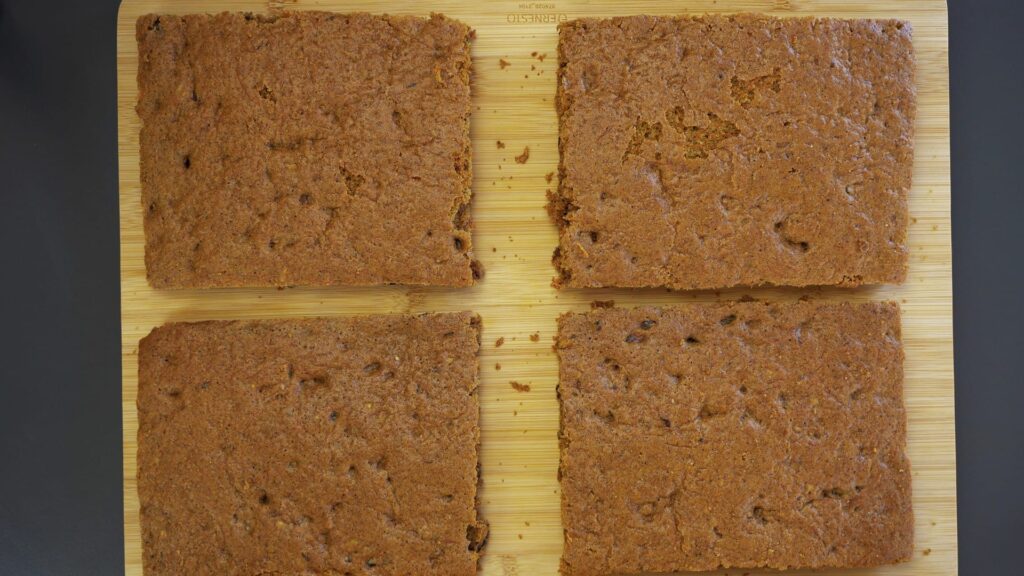 Cooling carrot cake layers before wrapping and storing them.