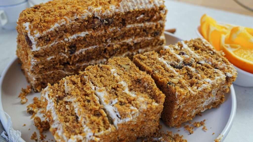 Carrot cake with cream cheese frosting, ready to be stored in the fridge.