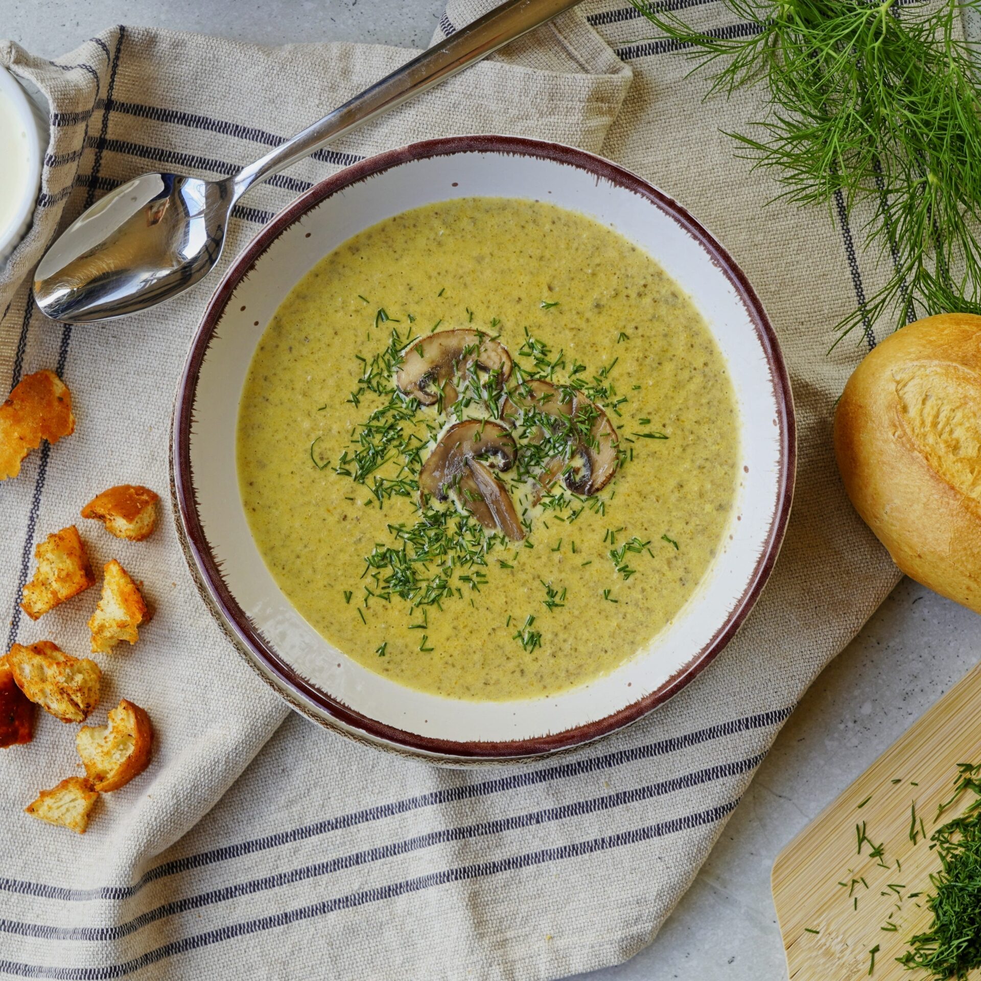 Creamy rustic Ukrainian mushroom soup garnished with aromatic mushrooms and dill.