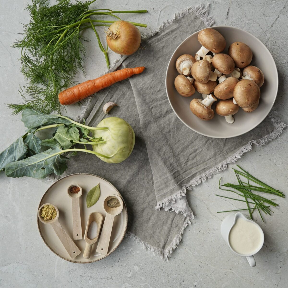 Ingredients for Ukrainian mushroom soup: champignons, vegetables, heavy cream, and a unique spice blend.