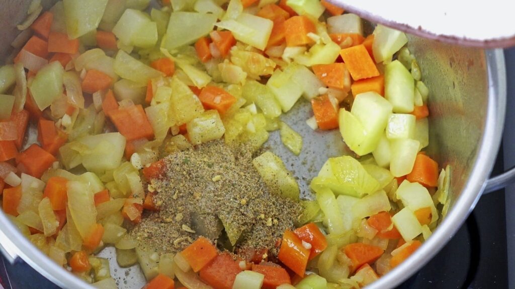 Adding spices to the vegetables for extra flavor.