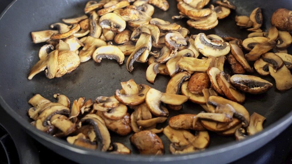 Frying mushrooms in a pan without oil to make them extra aromatic.