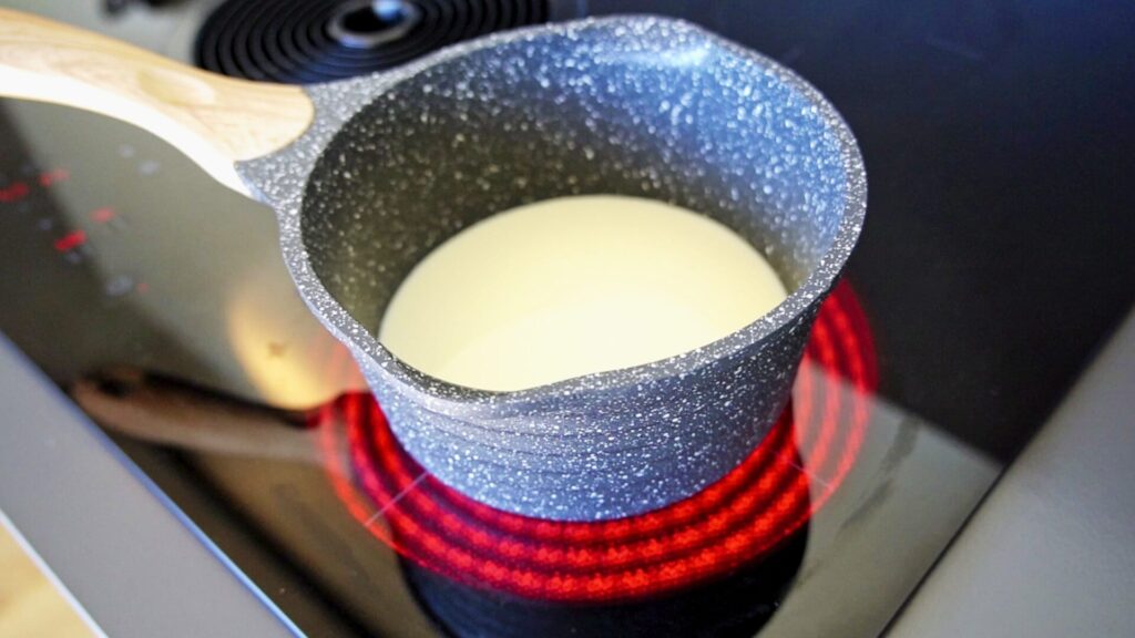 Heating milk before adding the remaining ingredients.